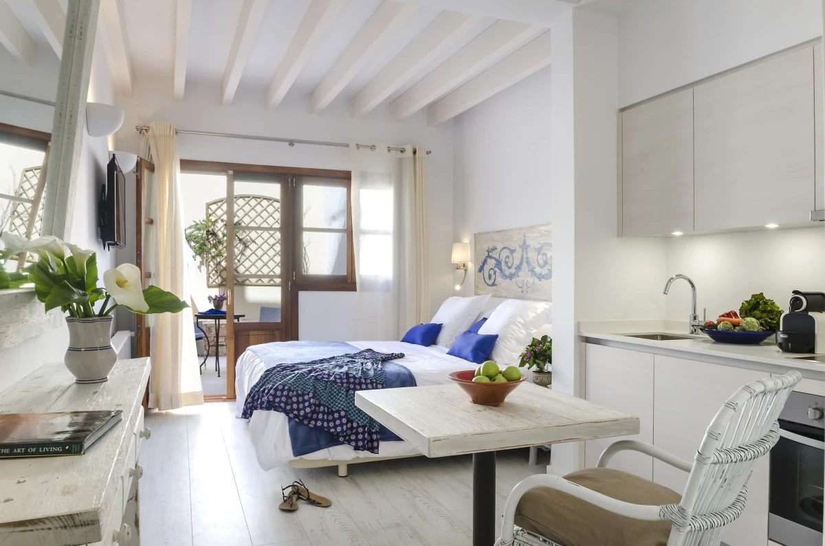 A studio with its bed, kitchen and seating area